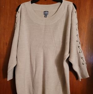 Cream color knit sweather with tie sleeves.